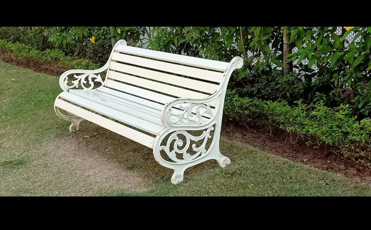 Decorative white wrought iron garden bench